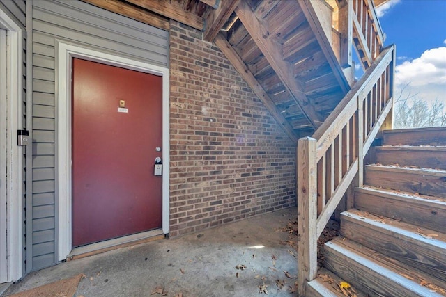 entrance to property featuring brick siding