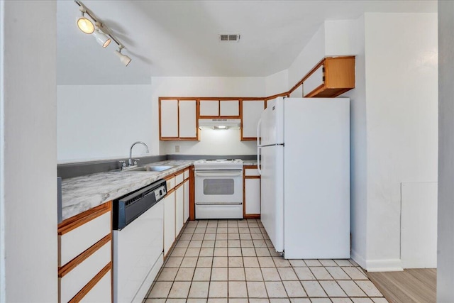 kitchen featuring visible vents, under cabinet range hood, light countertops, white appliances, and a sink