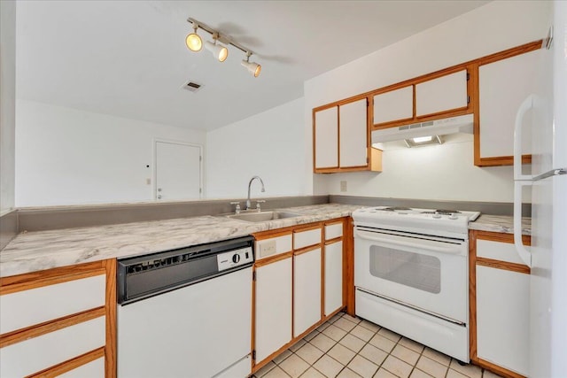 kitchen featuring visible vents, under cabinet range hood, light countertops, white appliances, and a sink