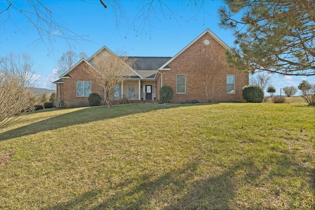 view of front of property featuring brick siding and a front lawn