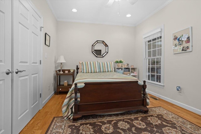 bedroom with ceiling fan, light wood-style flooring, baseboards, and ornamental molding