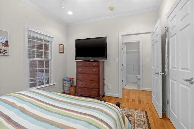 bedroom with baseboards, wood finished floors, and ornamental molding