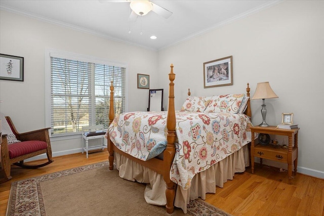 bedroom featuring ceiling fan, light wood-type flooring, crown molding, and baseboards