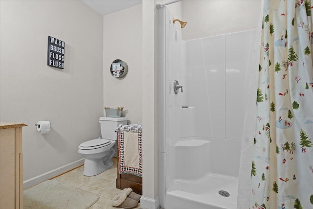 bathroom with tile patterned flooring, a shower stall, toilet, and baseboards