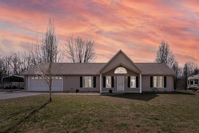 view of front of property with driveway, roof with shingles, a yard, a carport, and a garage