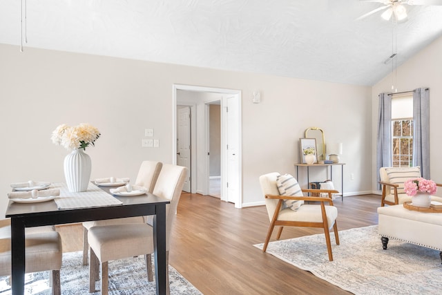 office space with lofted ceiling, a ceiling fan, baseboards, and light wood finished floors