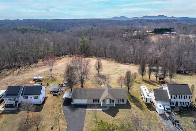 aerial view with a mountain view and a wooded view