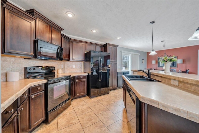 kitchen with black appliances, pendant lighting, a sink, wine cooler, and decorative backsplash