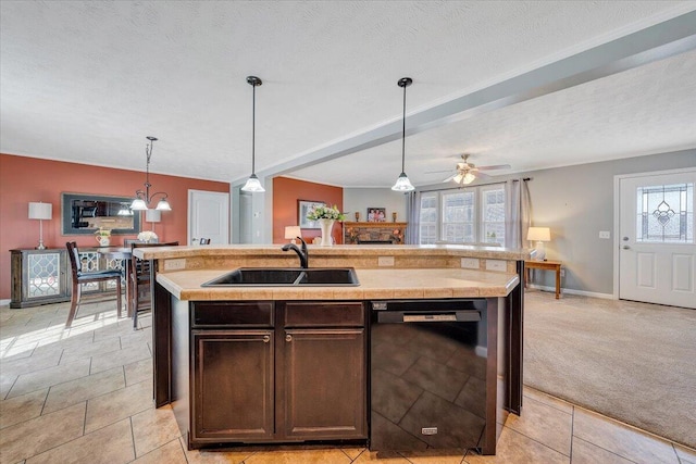 kitchen with light countertops, black dishwasher, plenty of natural light, and a sink