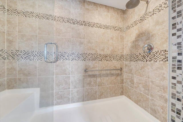 full bath with a tile shower