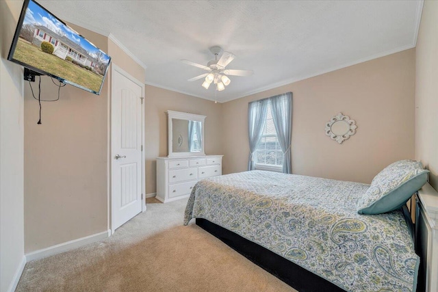 bedroom with light colored carpet, crown molding, baseboards, and ceiling fan