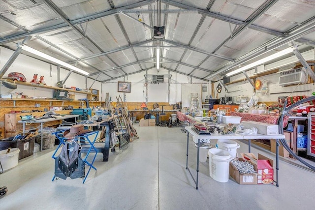 garage featuring a workshop area, a garage door opener, and a wall mounted AC