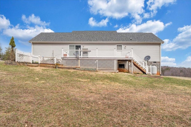 rear view of house featuring a deck, a yard, and stairs