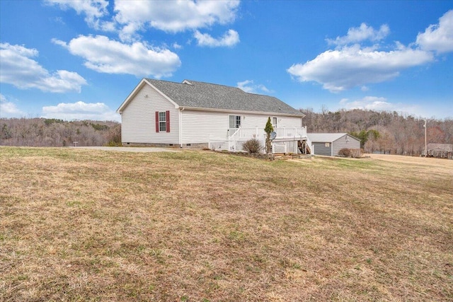 rear view of house with a lawn and crawl space