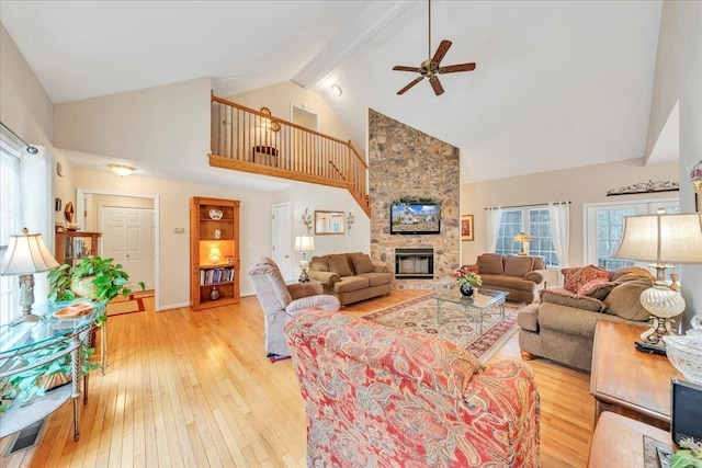 living room featuring light wood finished floors, a healthy amount of sunlight, and a fireplace