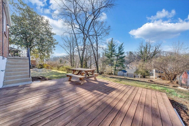 wooden terrace with stairway and a lawn