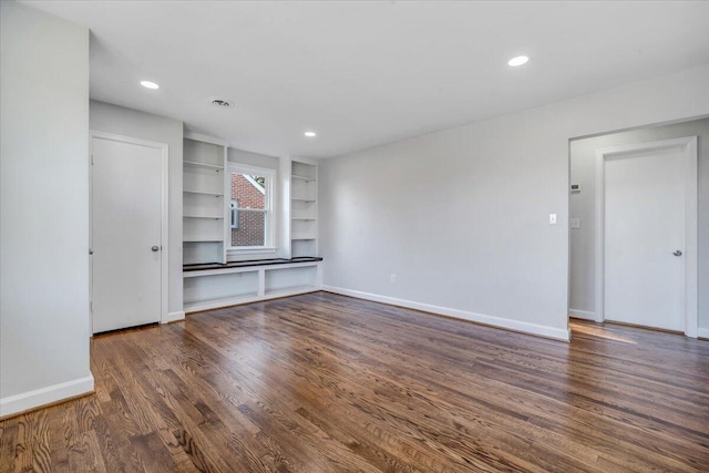 unfurnished living room featuring recessed lighting, wood finished floors, and baseboards