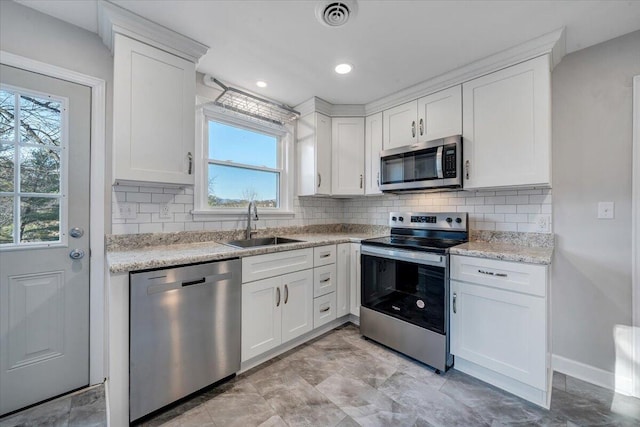 kitchen featuring white cabinetry, stainless steel appliances, and a sink