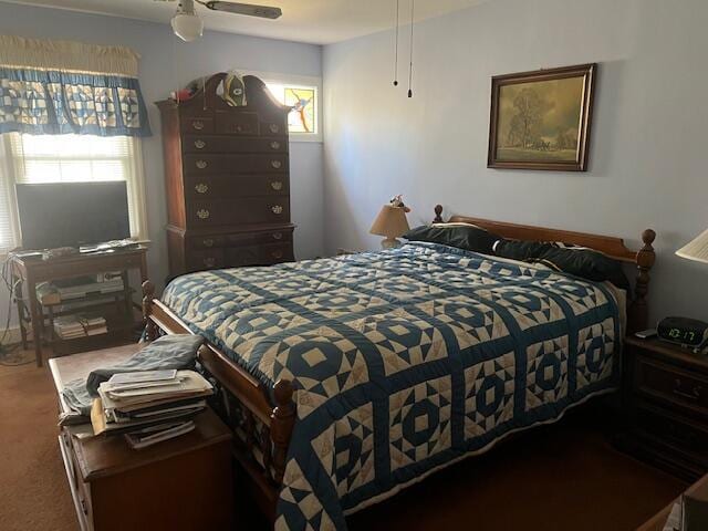 bedroom featuring carpet flooring, multiple windows, and ceiling fan