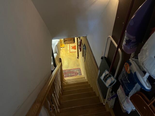 stairs featuring wood finished floors