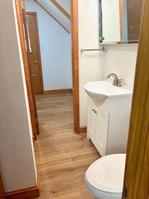 182 Dogwood Ln, Troutville, VA 24175 - half bathroom featuring toilet, vanity, baseboards, and wood finished floors