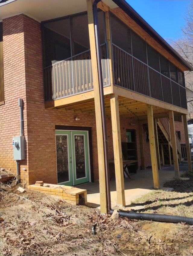 182 Dogwood Ln, Troutville, VA 24175 - rear view of house with brick siding, a patio, and a sunroom