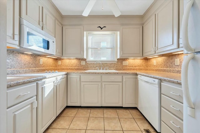 kitchen featuring light tile patterned floors, white appliances, white cabinetry, and a sink