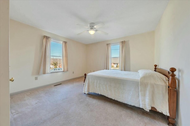 bedroom featuring visible vents, carpet floors, baseboards, and a ceiling fan