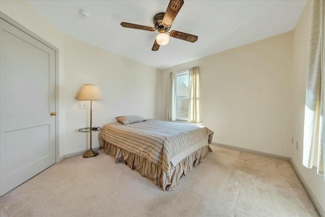 carpeted bedroom with baseboards and ceiling fan