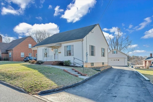 view of front of home featuring an outbuilding, a garage, and a front yard