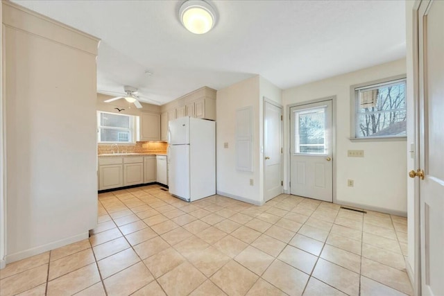 kitchen with decorative backsplash, a healthy amount of sunlight, white appliances, and light countertops