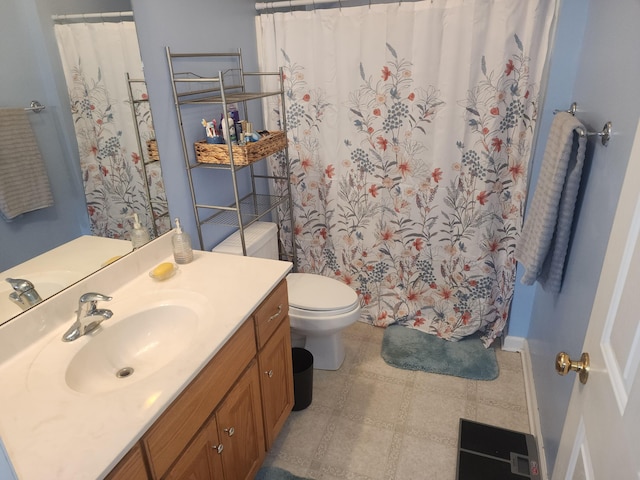 bathroom with toilet, vanity, and a shower with curtain