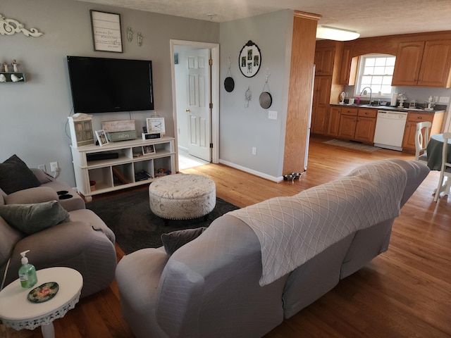 living room with light wood-type flooring and baseboards