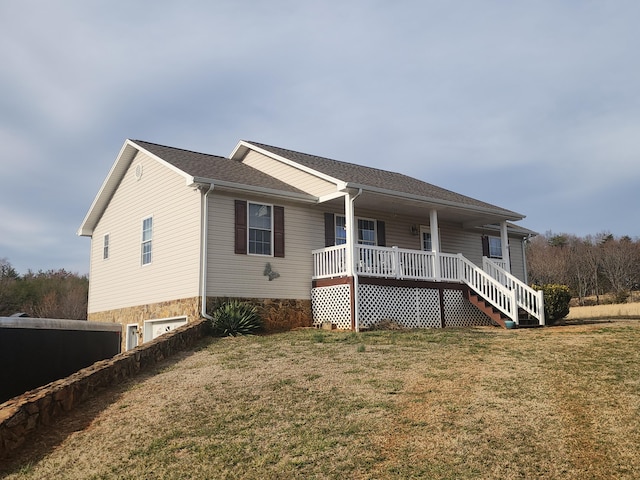 view of front of home featuring covered porch and a front lawn