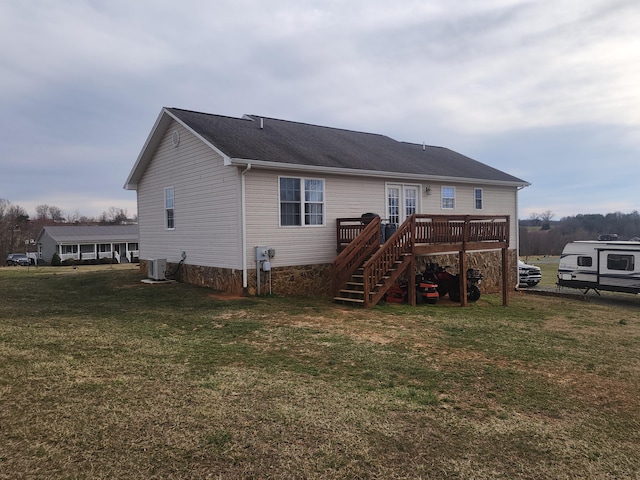 rear view of house featuring stairway, a yard, central AC, french doors, and a deck