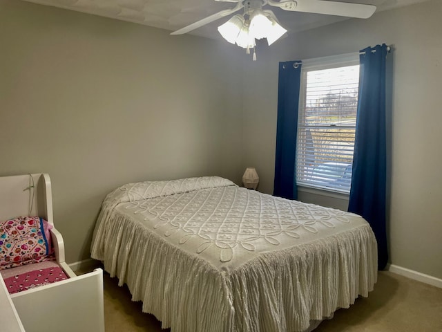 carpeted bedroom featuring a ceiling fan and baseboards