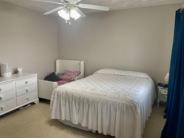 bedroom featuring ceiling fan and light carpet