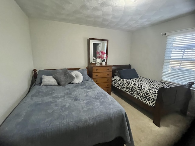 bedroom featuring light carpet