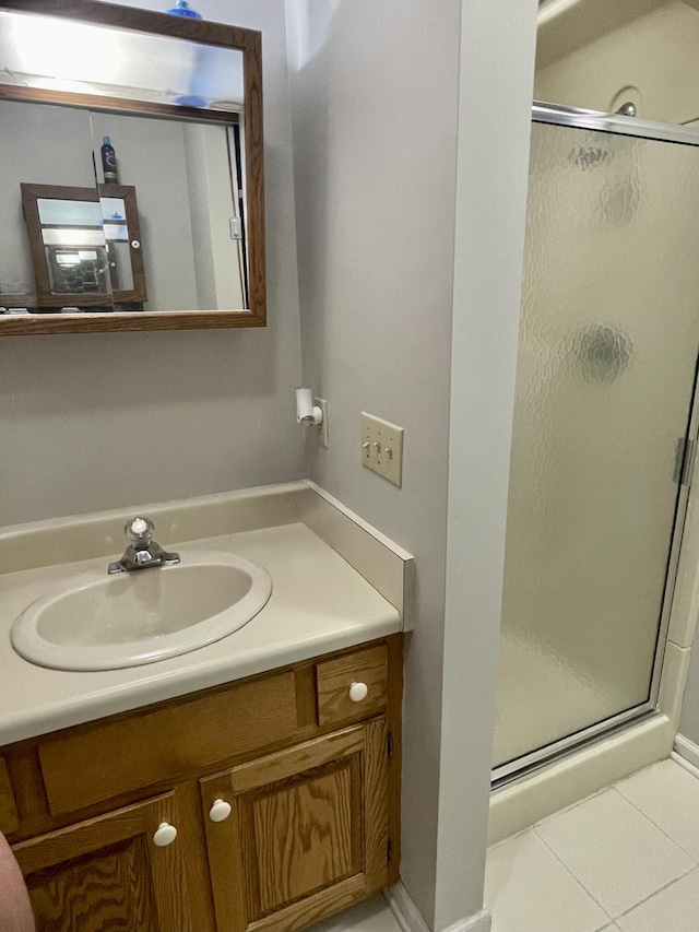 full bathroom with vanity, tile patterned floors, and a stall shower