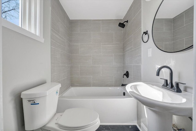 full bath with toilet, washtub / shower combination, and a sink
