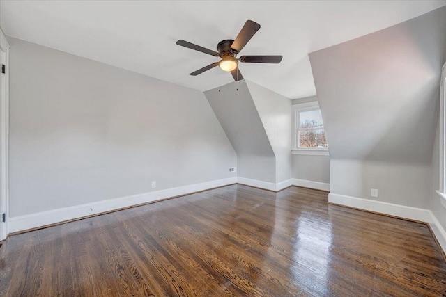 bonus room featuring baseboards, lofted ceiling, a ceiling fan, and wood finished floors