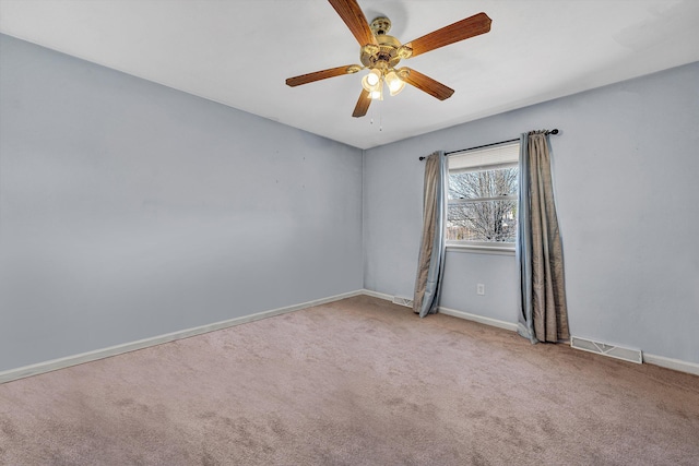 carpeted empty room featuring visible vents, ceiling fan, and baseboards