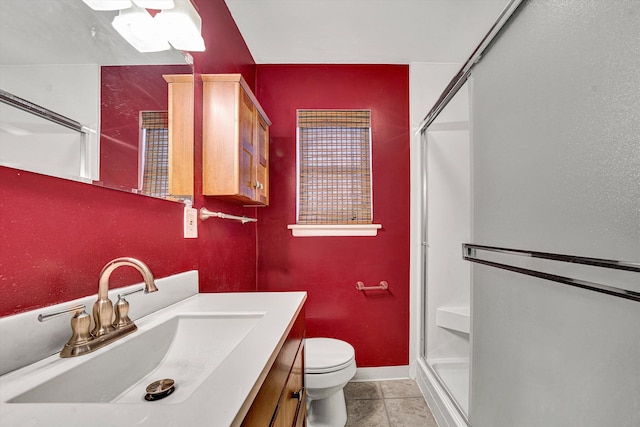 bathroom with vanity, baseboards, a shower stall, tile patterned floors, and toilet