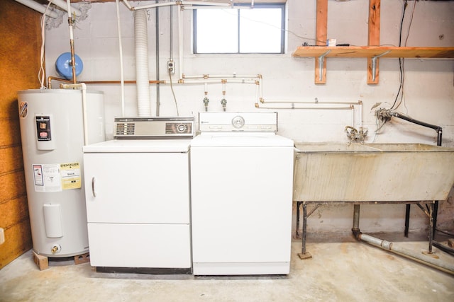 washroom with independent washer and dryer, laundry area, water heater, and a sink