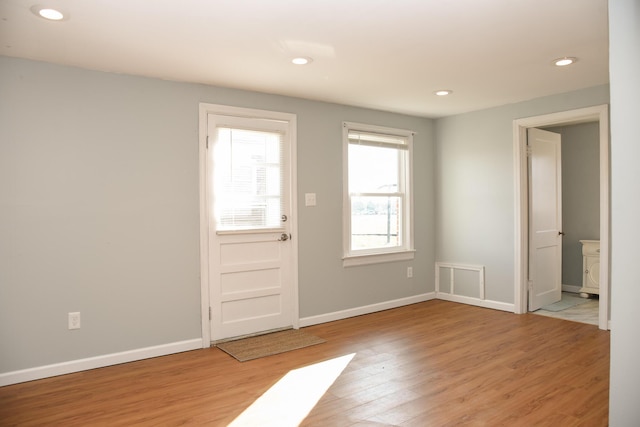 foyer with recessed lighting, light wood-type flooring, and baseboards