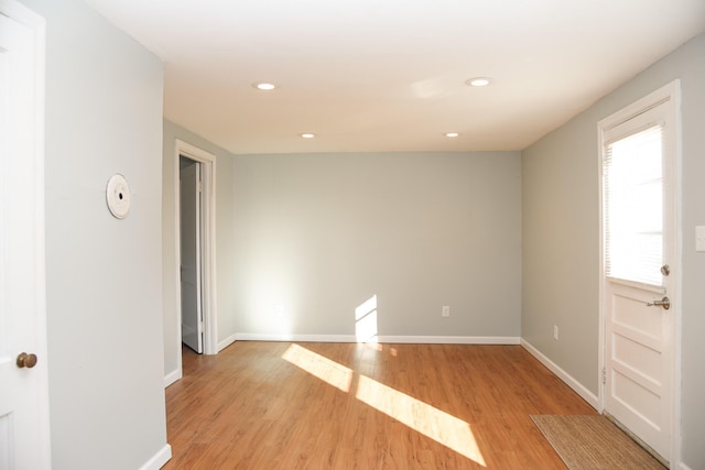 spare room with recessed lighting, baseboards, and light wood-style flooring