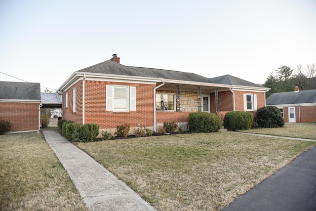 single story home with stone siding, brick siding, a chimney, and a front yard