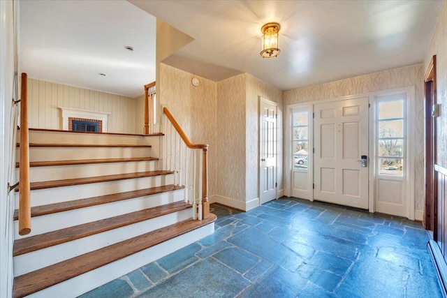 foyer entrance featuring stairway and stone tile flooring