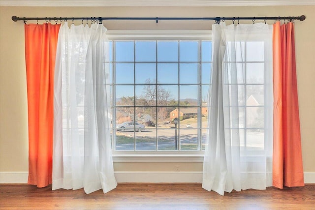 interior details featuring wood finished floors and baseboards