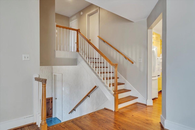 stairs with baseboards and wood finished floors